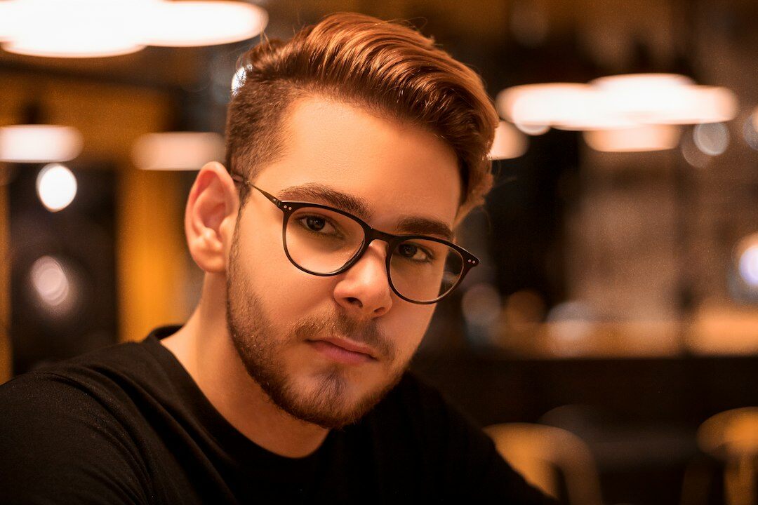 Distinguished Hispanic man wearing luxury prescription eyeglasses indoors
