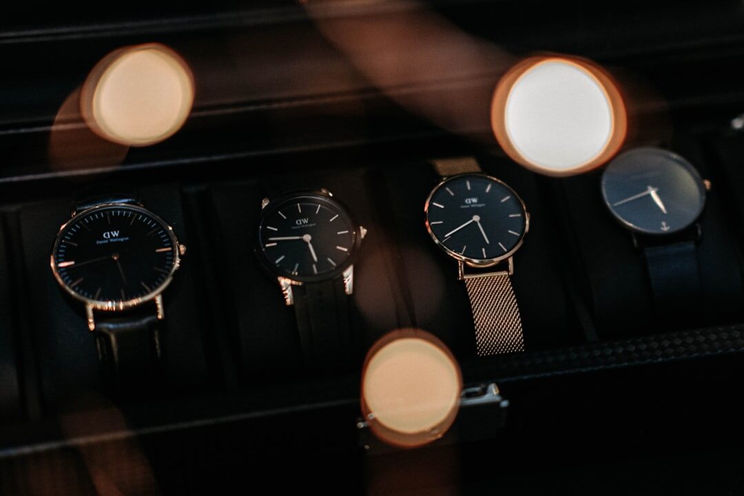 Velvet tray with three Swiss timepieces displayed on a marquetry table in a private boutique salon