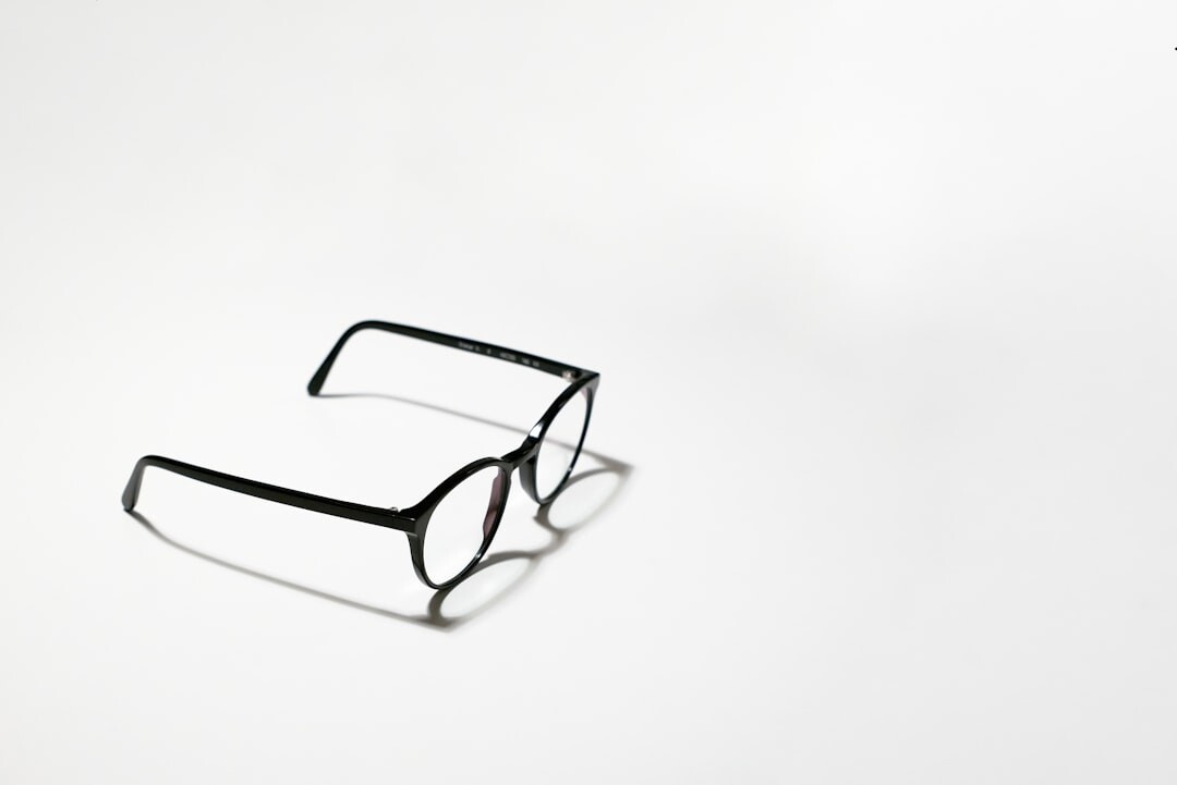 Handcrafted acetate eyewear frames arranged on a wooden atelier workbench