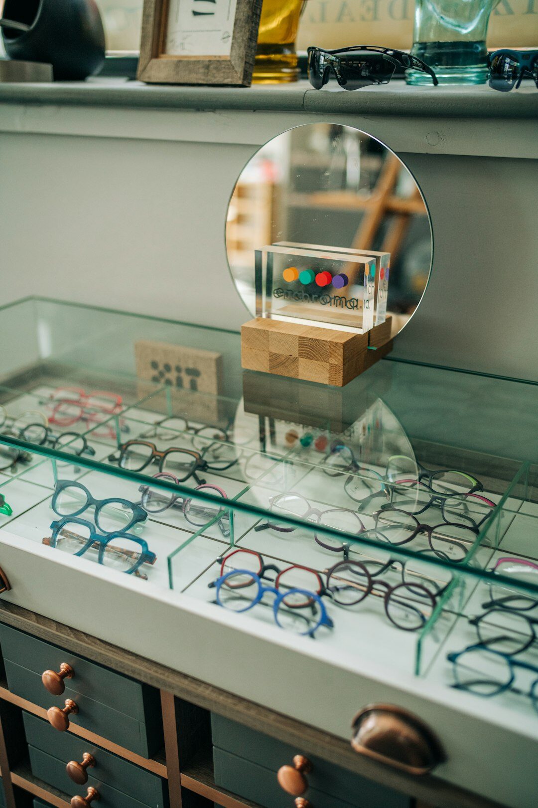 Eyewear frame options arranged on a wooden table in a private boutique consultation room